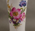 Zbliżenie na detale malatury florystycznej z amarantową dziką różą i bławatkiem na białej porcelanie