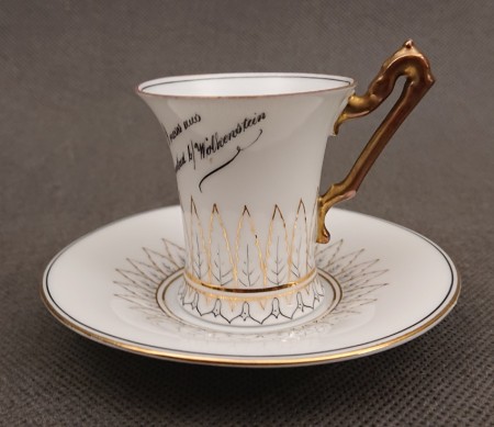 Zabytkowa porcelanowa filiżanka ze spodkiem Jaeger Marktredwitz z napisem Gruss aus Wolkenstein i pozłacanym uchem